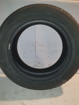 tire on the floor of a car with a white wall in the background