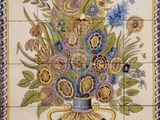 a painting of a vase of flowers on a tiled wall
