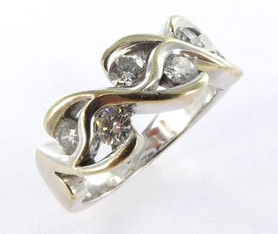 a close up of a diamond ring on a white surface