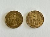 two gold coins, one of which is a woman and one of which is a man