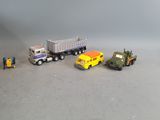several toy trucks are lined up in a row on a gray surface