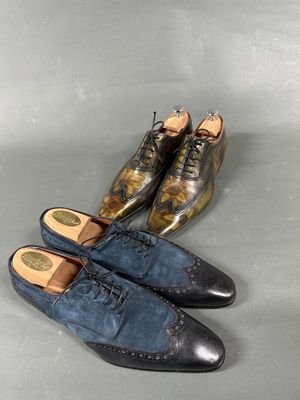 three pairs of shoes are lined up on a gray surface