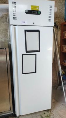 a white refrigerator that is sitting in the corner of a room