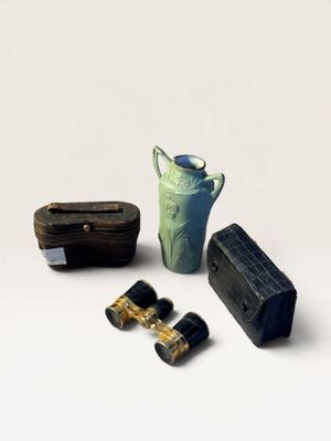 three binoculars, a vase, and a box on a white surface