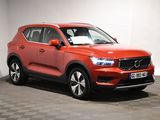 a red volvo suv parked in a garage