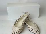 pair of white shoes with a box in the background