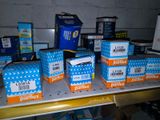 several boxes of various types of electronics are on a shelf