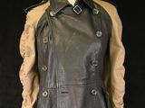 a black and tan leather jacket on a mannequin mannequin