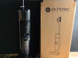 the vacuum is sitting on the table next to the box