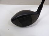 a close up of a golf club on a white surface