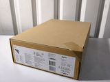 an open box sitting on top of a white table next to a white wall