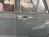 a car that is parked in the street with its door open