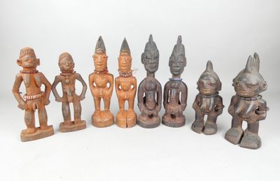 several wooden figurines of different sizes and shapes on a white surface