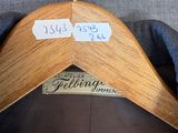a wooden hanger that has two tags on it