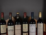 several bottles of wine are lined up in a row on a table