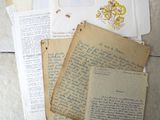 many old letters and papers sitting on the floor