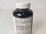 a bottle of black liquid sitting on a table