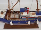 a model of a boat on display on a white surface
