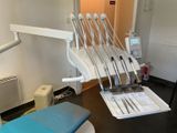 a dentist ' s chair in the corner of the room
