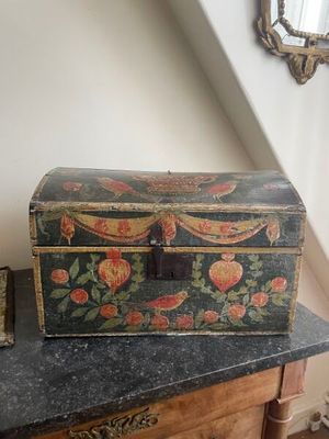 a small wooden box sitting on top of a dresser