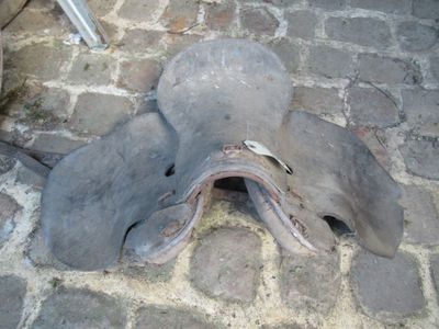 an old shoe that is laying on the ground