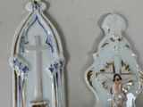 two religious items on a shelf next to each other