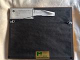 a picture of a black folder on a bed