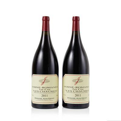 two bottles of red wine sitting next to each other on a white surface
