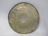a gold plate that is sitting on a white surface
