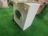 a washing machine sitting on the floor in a room