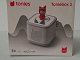 packaging of a box with a toy sitting on top of it