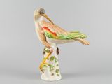 figurine en porcelaine représentant un oiseau perché sur une souche d'arbre