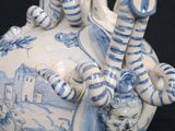 a blue and white vase with a dragon on it