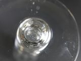 a close up of a wine glass with water in it