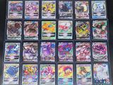 a large collection of pokemon cards in plastic cases on a table