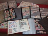 many different types of stamps on a red table