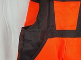 a close up of an orange and black vest on a white background
