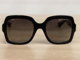 a close up of a pair of black sunglasses on a table