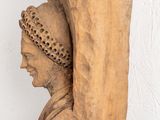 a sculpture of a woman with a hat on it ' s head