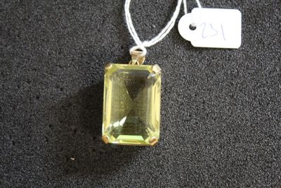 pendentif en cristal jaune avec une étiquette sur un fond noir