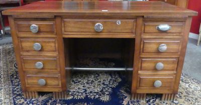 a wooden desk with drawers and a mirror on top of it