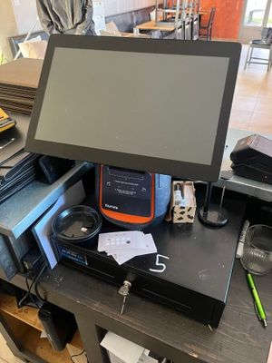 an image of a desk with a monitor and other electronics