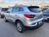 the rear end of a silver suv parked in a parking lot