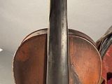 a violin and a violin case sitting on a table