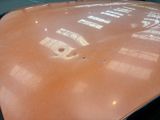 a close up of a car ' s hood with a bullet hole in it
