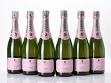 six bottles of champagne are lined up in a row