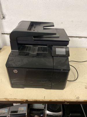 a printer sitting on top of a wooden table
