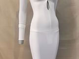 the dress is white and has long sleeves and a deep v - neck