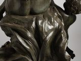 a bronze statue of a woman holding a child