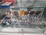 a glass display case full of video games on display